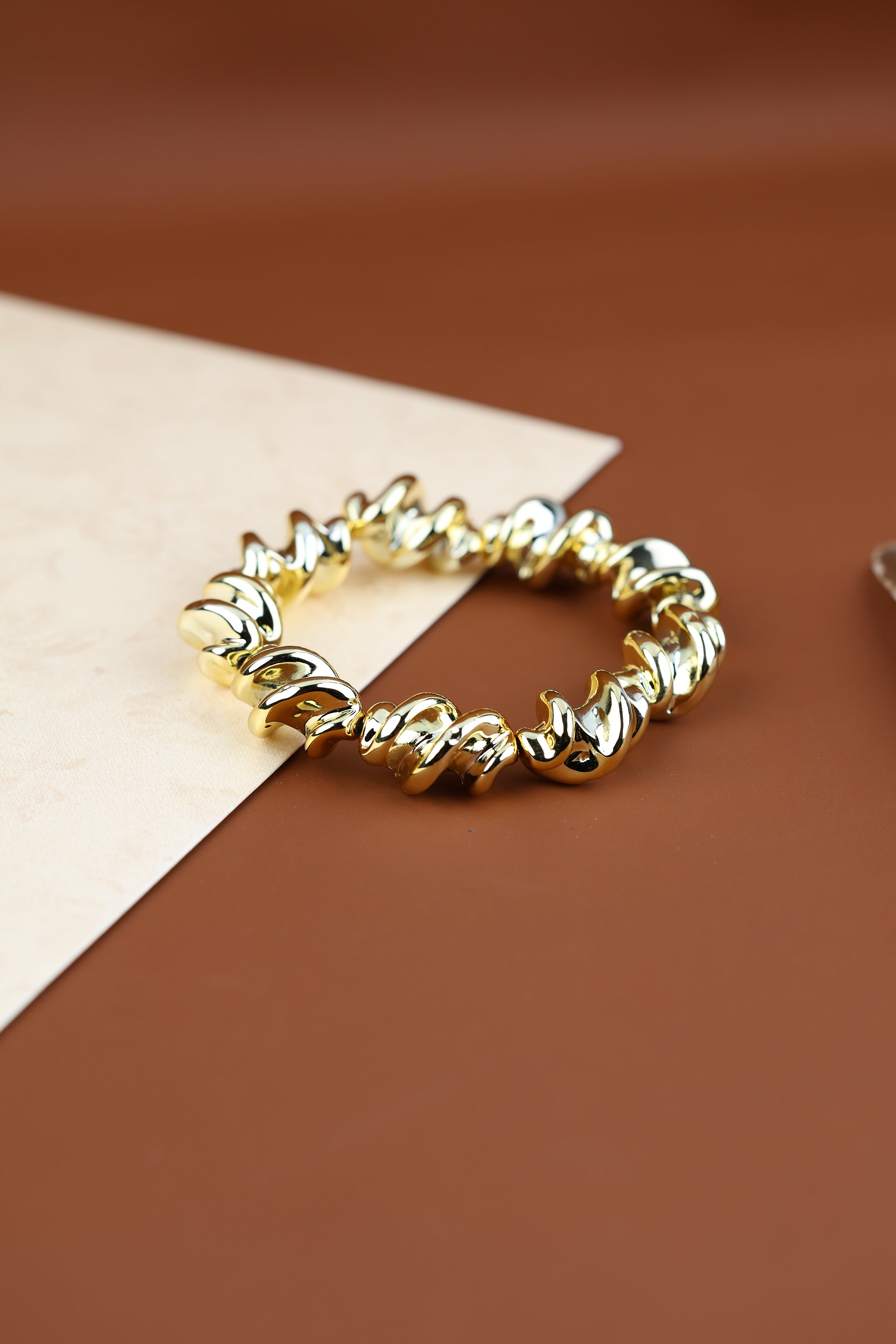 Gold-tone twisted statement fashion bracelet by Temple Dollar